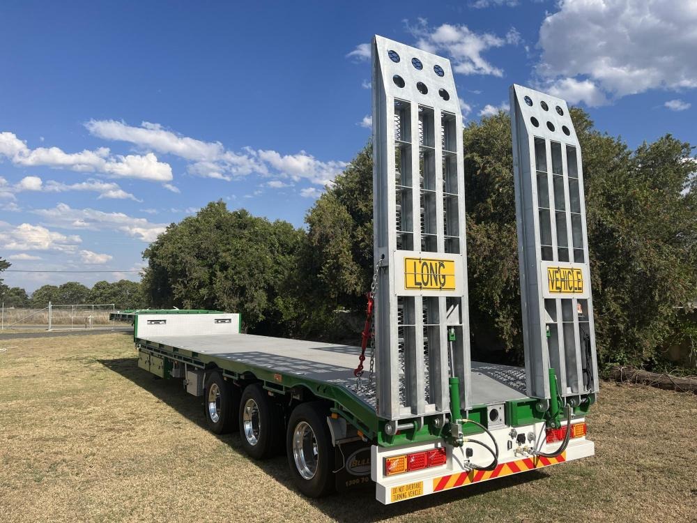 A green drop deck trailer