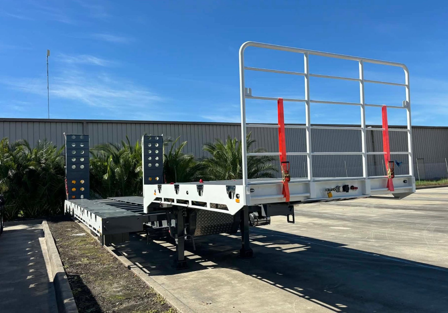 A white drop deck trailer